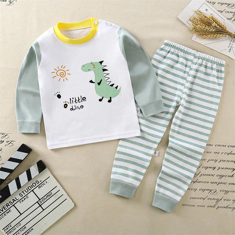 Children's pajama set with dinosaur design on a beige background